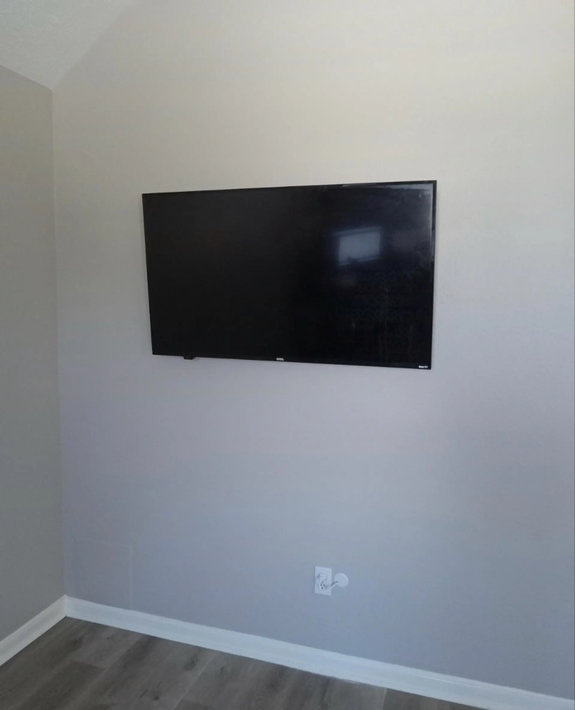 Custom TV installation with precision leveling and height adjustment for perfect eye-level viewing