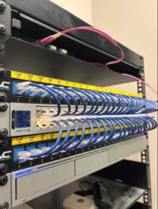 Expertly labeled network patch panels and cable management solutions for optimized office IT infrastructure.